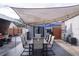 Outdoor patio featuring a canvas canopy, string lights, and a table with six chairs at 314 E Althea Ave, Tampa, FL 33612