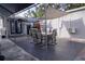 Outdoor patio with dark stone pavers, a canvas canopy, and a table with four chairs at 314 E Althea Ave, Tampa, FL 33612