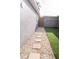 Side yard featuring artificial grass, stepping stones, and a rock bed at 314 E Althea Ave, Tampa, FL 33612