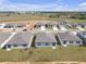 An aerial view of a neighborhood featuring one-story homes with gray roofs at 31622 Malbec Dr, Brooksville, FL 34602