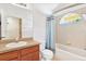 Bright bathroom features a vanity with a tub and shower combo at 31833 Turkeyhill Dr, Wesley Chapel, FL 33543