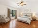 Bright bedroom features a ceiling fan, neutral walls, and ample natural light from the large window at 31833 Turkeyhill Dr, Wesley Chapel, FL 33543