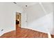Minimalist bedroom featuring wood floors and a view to a living room at 31833 Turkeyhill Dr, Wesley Chapel, FL 33543