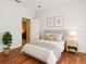 Bright bedroom features neutral tones, wood floor and a cozy bed at 31833 Turkeyhill Dr, Wesley Chapel, FL 33543