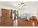 Bright bedroom features wood floors, ceiling fan, and window view at 31833 Turkeyhill Dr, Wesley Chapel, FL 33543