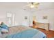 Comfortable bedroom with wood floors, white walls and ensuite bathroom at 31833 Turkeyhill Dr, Wesley Chapel, FL 33543