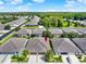Aerial view of a home in a community featuring lush green landscaping and a two car garage at 31833 Turkeyhill Dr, Wesley Chapel, FL 33543