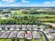 Beautiful aerial view of homes nestled within a lush landscape featuring multiple ponds and mature trees under a bright blue sky at 31833 Turkeyhill Dr, Wesley Chapel, FL 33543