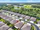 Aerial view of a home in a community with lush green landscaping and surrounding water features at 31833 Turkeyhill Dr, Wesley Chapel, FL 33543