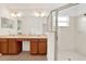 Bathroom features a double sink vanity, glass shower, and tile flooring at 31833 Turkeyhill Dr, Wesley Chapel, FL 33543