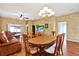 Spacious living area with hardwood floors, dining area with chandelier, providing ample room for relaxation and entertainment at 31833 Turkeyhill Dr, Wesley Chapel, FL 33543