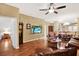 Inviting open concept living area with hardwood floors seamlessly connecting living, dining, and kitchen spaces at 31833 Turkeyhill Dr, Wesley Chapel, FL 33543
