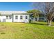 View of the backyard featuring a well maintained lawn and views of the neighbors home at 3346 Gorse Ct, Palm Harbor, FL 34684