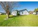 Well-maintained home with lush lawn and mature landscaping on a sunny day at 3346 Gorse Ct, Palm Harbor, FL 34684
