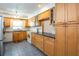 Spacious kitchen featuring wood cabinets, tile backsplash, and modern appliances at 3346 Gorse Ct, Palm Harbor, FL 34684