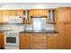 Beautiful kitchen featuring wood cabinets, modern appliances, and an opening to the living room at 3346 Gorse Ct, Palm Harbor, FL 34684