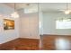 Bright living room featuring hardwood floors, natural light, and an opening to the kitchen with stainless steel appliances at 3346 Gorse Ct, Palm Harbor, FL 34684