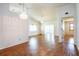 Spacious and airy living room featuring hardwood floors, ceiling fan, and opening to additional rooms at 3346 Gorse Ct, Palm Harbor, FL 34684