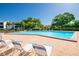 Community pool featuring chaise lounge chairs, landscaping and plenty of room for residents to relax and unwind at 3346 Gorse Ct, Palm Harbor, FL 34684