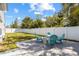 Beautiful backyard with patio, fire pit, and lush green lawn at 3352 Honeymoon Ln, Holiday, FL 34691