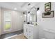 Bright bathroom features a glass shower, modern vanity, and decorative shelving at 3352 Honeymoon Ln, Holiday, FL 34691
