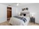 Well-lit bedroom showcasing a cedar closet, modern art, and calming neutral tones at 3352 Honeymoon Ln, Holiday, FL 34691