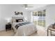 Serene bedroom with large sliding doors, a decorative wall art, and comfortable furnishings at 3352 Honeymoon Ln, Holiday, FL 34691