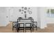 Bright dining area with marble topped table, black chairs, and a modern mirror display at 3352 Honeymoon Ln, Holiday, FL 34691