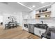 Bright open kitchen featuring white cabinets, stainless steel appliances, modern fixtures, and a dining area at 3352 Honeymoon Ln, Holiday, FL 34691