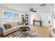 Spacious living room with modern furnishings, stylish rug, and large windows at 3352 Honeymoon Ln, Holiday, FL 34691