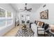 Bright living room with stylish decor, plush daybed, and access to a private patio through glass doors at 3352 Honeymoon Ln, Holiday, FL 34691
