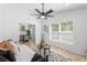 Inviting living room featuring modern decor, light wood floors, and seamless transition into the dining area at 3352 Honeymoon Ln, Holiday, FL 34691