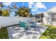 Outdoor patio featuring a fire pit and blue Adirondack chairs, perfect for relaxing at 3352 Honeymoon Ln, Holiday, FL 34691