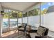 Comfortable screened porch with patio view and outdoor seating area at 3352 Honeymoon Ln, Holiday, FL 34691