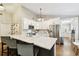 Beautiful kitchen featuring white cabinets, stainless steel appliances, and a large island with chairs at 3823 W Obispo St, Tampa, FL 33629