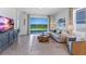 Bright living room with neutral tones, a cozy sectional, and a view of the water at 4054 Westwood Fields Loop, Plant City, FL 33565