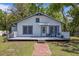 Charming home with brick walkway leading to a cozy front porch at 4407 Hill Dr, Valrico, FL 33596