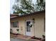 Charming entrance with flowers, muted shutters, and a cream colored stucco exterior at 4594 Mohican Trl # 143, Sarasota, FL 34233