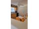 Bright kitchen with wooden cabinets, a ceiling fan, and a cozy eating area at 4594 Mohican Trl # 143, Sarasota, FL 34233
