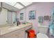 Standard bathroom with a clean sink, a framed sailing print, and a toilet at 4885 1St Ne St # 305, St Petersburg, FL 33703