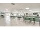Large community room with tables, chairs, and televisions at 4885 1St Ne St # 305, St Petersburg, FL 33703