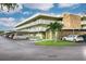 View of the condo's exterior with covered parking and well maintained facade on a sunny day at 4885 1St Ne St # 305, St Petersburg, FL 33703