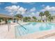 Community swimming pool with American flag, sundeck, and lounge chairs at 4885 1St Ne St # 305, St Petersburg, FL 33703
