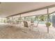 A covered poolside patio seating area with tables and chairs at 4885 1St Ne St # 305, St Petersburg, FL 33703