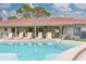 Pool with sun loungers and shaded patio at 4885 1St Ne St # 305, St Petersburg, FL 33703