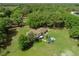 Aerial view of the house featuring an in-ground pool and lush green landscape providing a private oasis at 4902 Five Acre Rd, Plant City, FL 33565