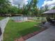 Large, partially fenced backyard features an above ground pool and a gazebo at 4902 Five Acre Rd, Plant City, FL 33565