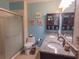 Bathroom featuring double granite countertops, shower, and blue walls at 4902 Five Acre Rd, Plant City, FL 33565