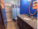 Bathroom featuring granite countertops, shower, and oval mirror at 4902 Five Acre Rd, Plant City, FL 33565