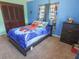 Bedroom featuring carpet, windows, and Spiderman decor at 4902 Five Acre Rd, Plant City, FL 33565